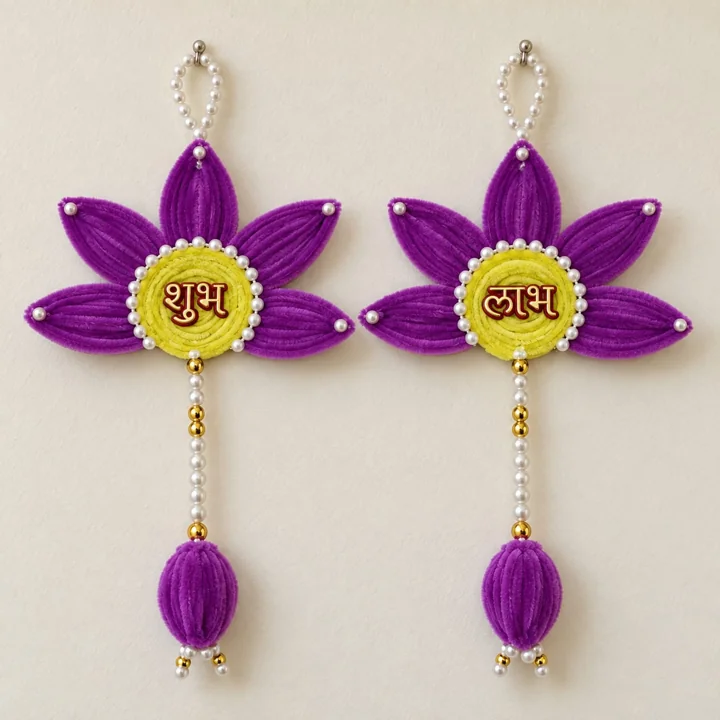 Purple petals and yellow centres with Shubh Labh lettering, pearl-like strings and purple floral drops. A pair is pictured.